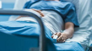 Victim of medical malpractice sleeping in a bed